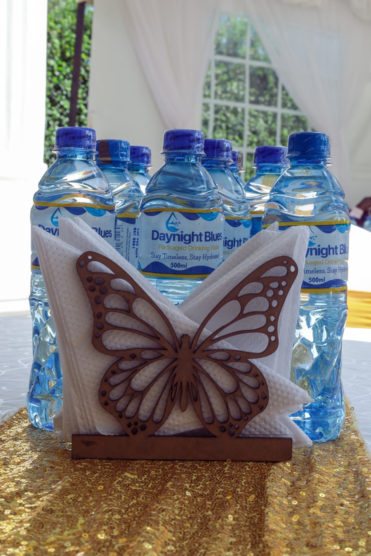 Daynight Blues bottles behind a butterfly napkin holder on a decorated event table